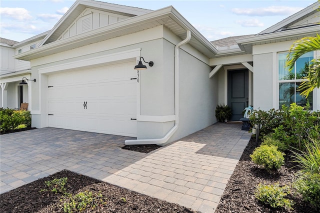 15830 Appalachian Dr, Punta Gorda, FL 33982 - view of side of home with a garage, board and batten siding, stucco siding, and driveway