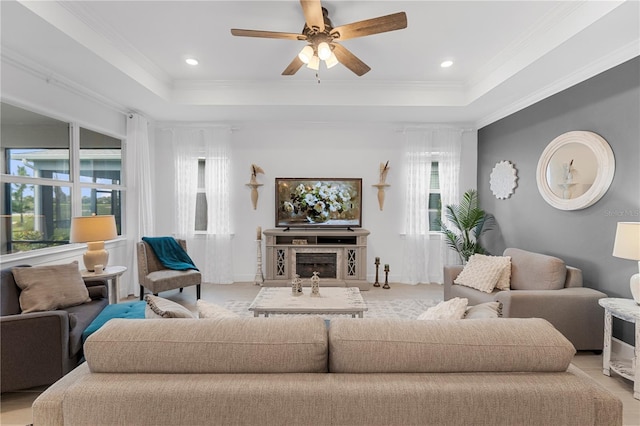 15830 Appalachian Dr, Punta Gorda, FL 33982 - living room featuring a ceiling fan, a tray ceiling, ornamental molding, and baseboards
