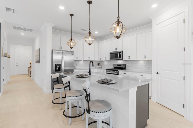 15830 Appalachian Dr, Punta Gorda, FL 33982 - kitchen featuring a sink, a breakfast bar area, stainless steel appliances, backsplash, and visible vents