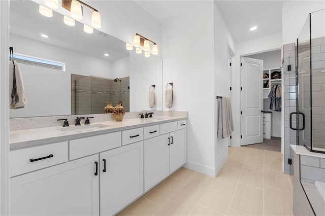 15830 Appalachian Dr, Punta Gorda, FL 33982 - bathroom featuring double vanity, a spacious closet, a sink, and a stall shower