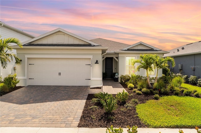 15830 Appalachian Dr, Punta Gorda, FL 33982 - ranch-style house featuring a garage, decorative driveway, board and batten siding, and stucco siding