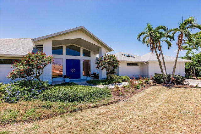 view of front of property featuring an attached garage, concrete driveway, and stucco siding