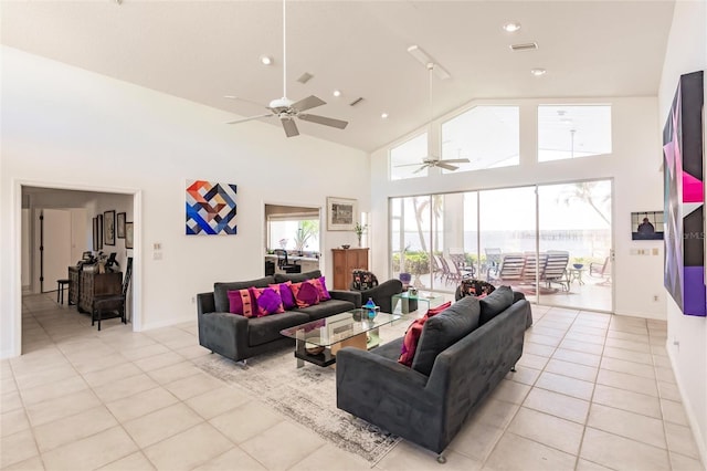 living area featuring light tile patterned floors, visible vents, recessed lighting, a ceiling fan, and high vaulted ceiling