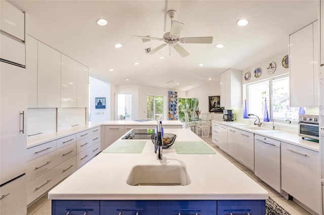 kitchen featuring white cabinets, a ceiling fan, blue cabinetry, and dishwasher