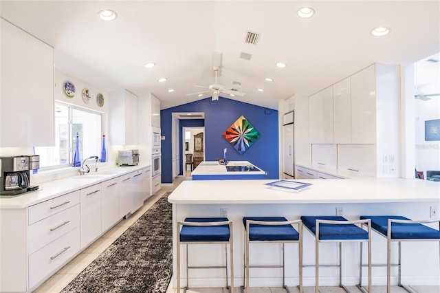 kitchen with white cabinets, a ceiling fan, modern cabinets, and a sink