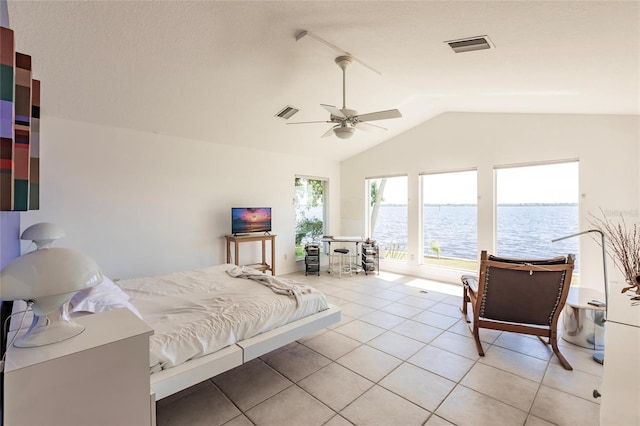 bedroom featuring light tile patterned floors, visible vents, a ceiling fan, and vaulted ceiling