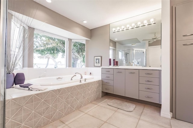 bathroom featuring a shower stall, vanity, a bath, a ceiling fan, and tile patterned flooring