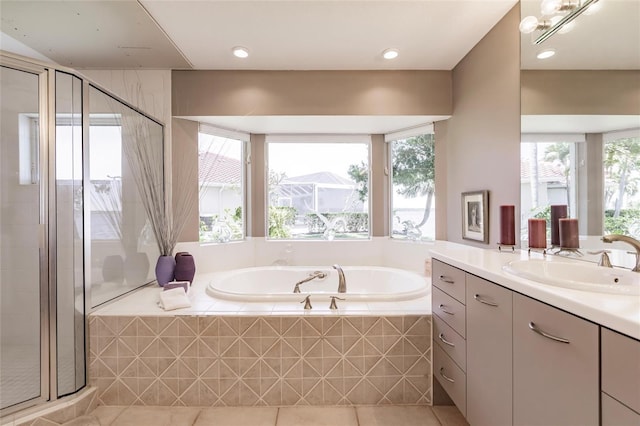 bathroom with tile patterned floors, a garden tub, vanity, and a stall shower
