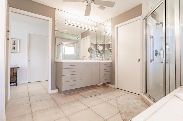 full bathroom with tile patterned floors, ceiling fan, a shower stall, and vanity