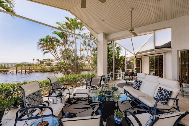 view of patio featuring ceiling fan, a water view, and an outdoor hangout area