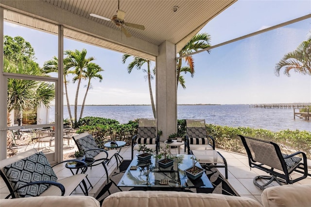 view of patio / terrace with outdoor dining space, a water view, and ceiling fan
