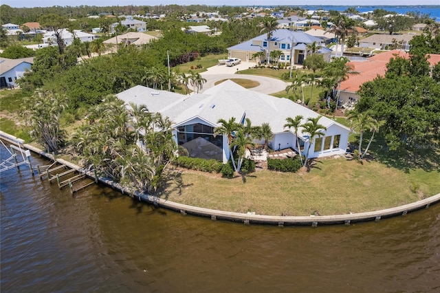 birds eye view of property featuring a water view and a residential view