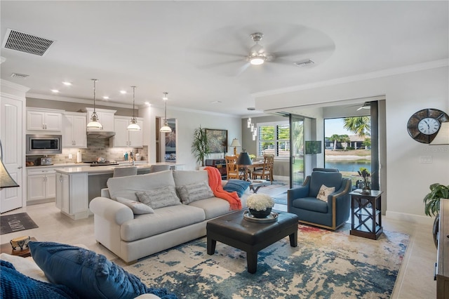 1745 Hyssop Loop, North Port, FL 34289 - living room with a ceiling fan, crown molding, baseboards, and recessed lighting