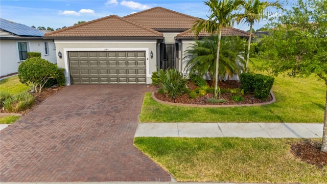 1745 Hyssop Loop, North Port, FL 34289 - single story home featuring decorative driveway, an attached garage, a tiled roof, and a front yard