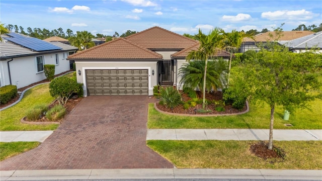 1745 Hyssop Loop, North Port, FL 34289 - view of front of house featuring a garage, decorative driveway, a front lawn, stucco siding, and a tile roof