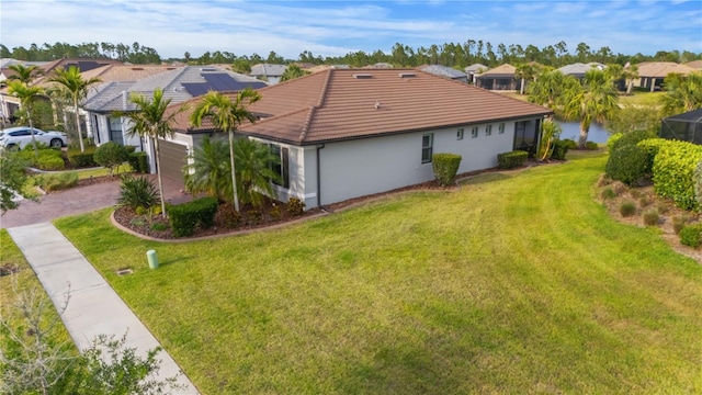 1745 Hyssop Loop, North Port, FL 34289 - view of home's exterior with a lawn, a residential view, driveway, and stucco siding