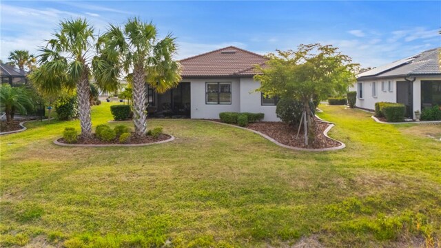 1745 Hyssop Loop, North Port, FL 34289 - view of front of home featuring stucco siding, a front lawn, and a tile roof