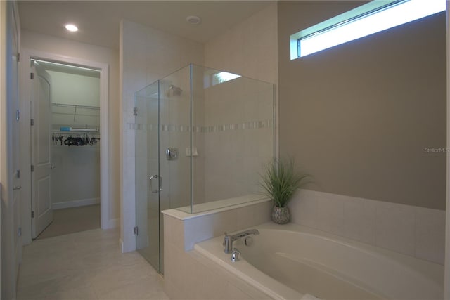 1745 Hyssop Loop, North Port, FL 34289 - bathroom with a stall shower, a garden tub, a spacious closet, and tile patterned flooring