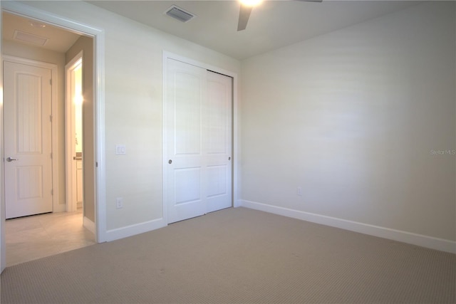 1745 Hyssop Loop, North Port, FL 34289 - unfurnished bedroom with light carpet, a closet, and a ceiling fan