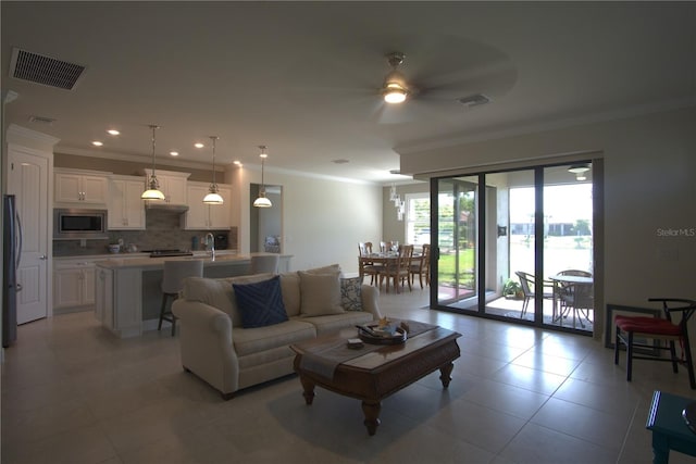 1745 Hyssop Loop, North Port, FL 34289 - living area with a ceiling fan, crown molding, light tile patterned floors, and recessed lighting