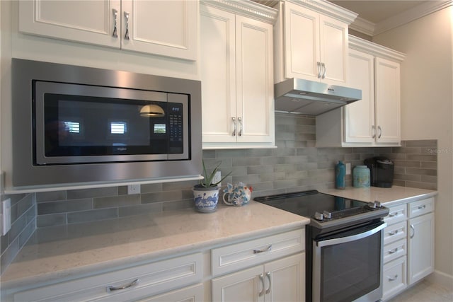 1745 Hyssop Loop, North Port, FL 34289 - kitchen with appliances with stainless steel finishes, under cabinet range hood, crown molding, white cabinetry, and tasteful backsplash