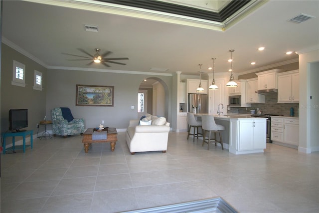 1745 Hyssop Loop, North Port, FL 34289 - living room featuring crown molding, arched walkways, a ceiling fan, light tile patterned floors, and recessed lighting