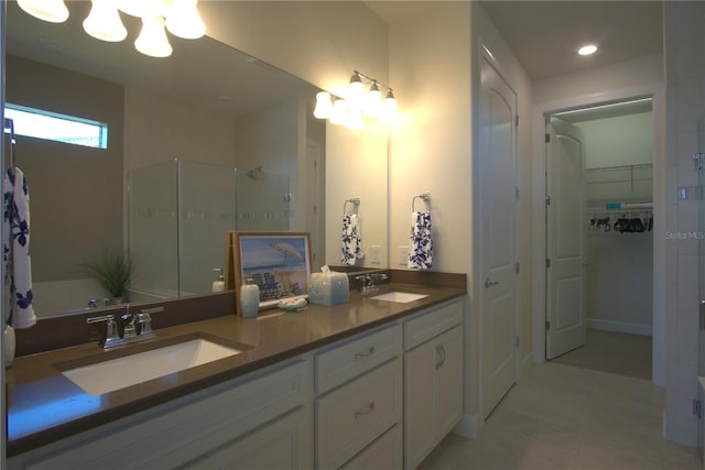 1745 Hyssop Loop, North Port, FL 34289 - bathroom featuring a chandelier, double vanity, tiled shower, a spacious closet, and recessed lighting