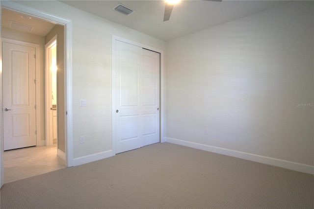 1745 Hyssop Loop, North Port, FL 34289 - unfurnished bedroom with light carpet, a closet, and a ceiling fan