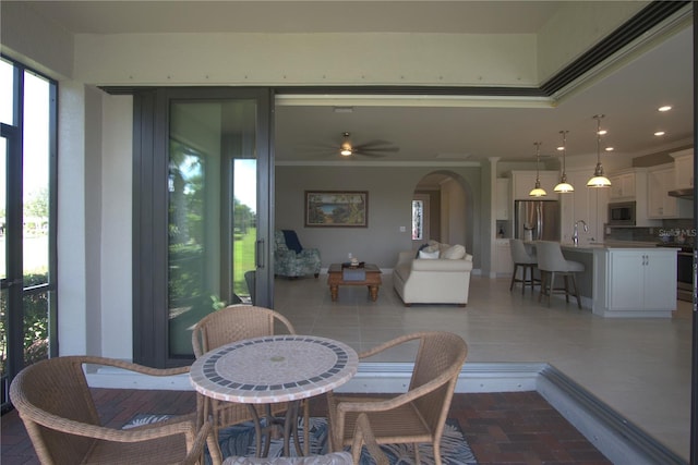 1745 Hyssop Loop, North Port, FL 34289 - dining room with arched walkways, crown molding, ceiling fan, and recessed lighting