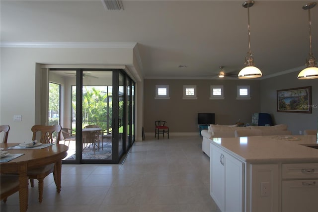 1745 Hyssop Loop, North Port, FL 34289 - kitchen featuring ceiling fan, crown molding, white cabinets, and plenty of natural light