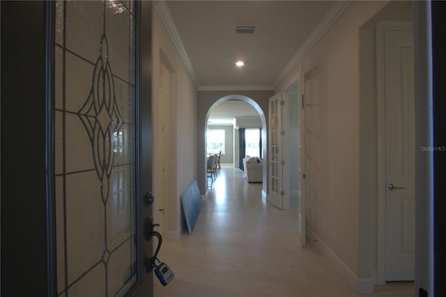 1745 Hyssop Loop, North Port, FL 34289 - hallway with arched walkways, crown molding, recessed lighting, and french doors