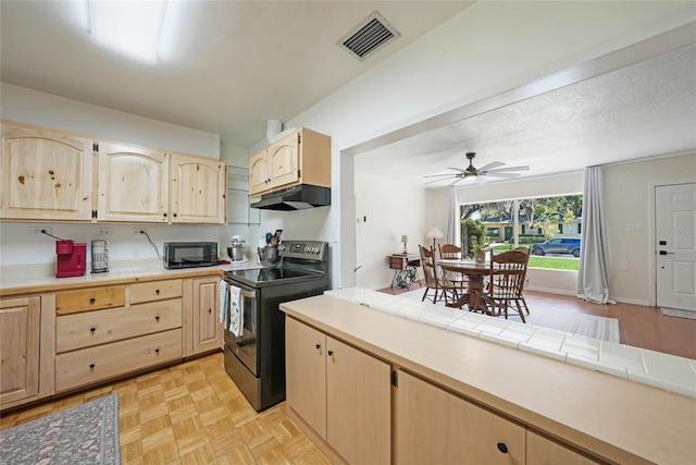 kitchen featuring under cabinet range hood, visible vents, black appliances, and light brown cabinets