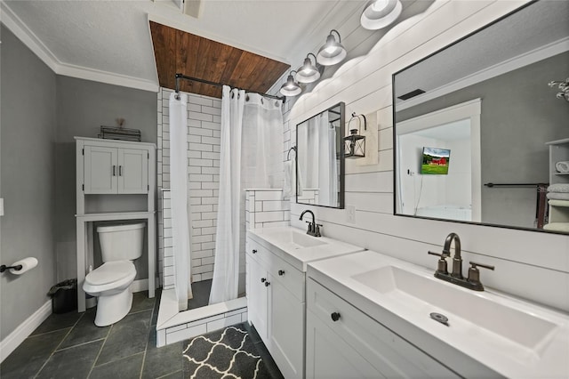 bathroom featuring a shower stall, crown molding, a sink, baseboards, and toilet