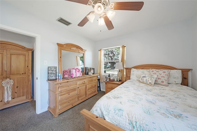 carpeted bedroom with baseboards, visible vents, and a ceiling fan