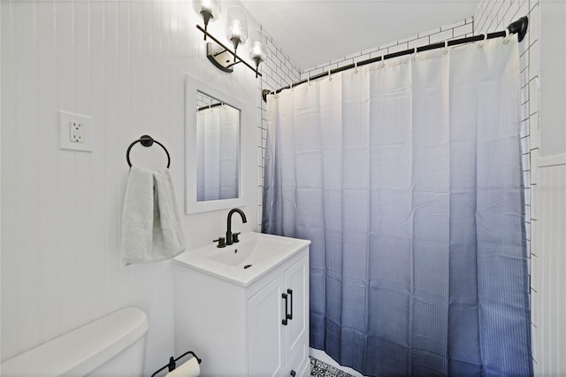 bathroom with toilet, vanity, and a shower with shower curtain