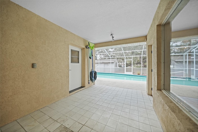 view of patio featuring an outdoor pool and a lanai