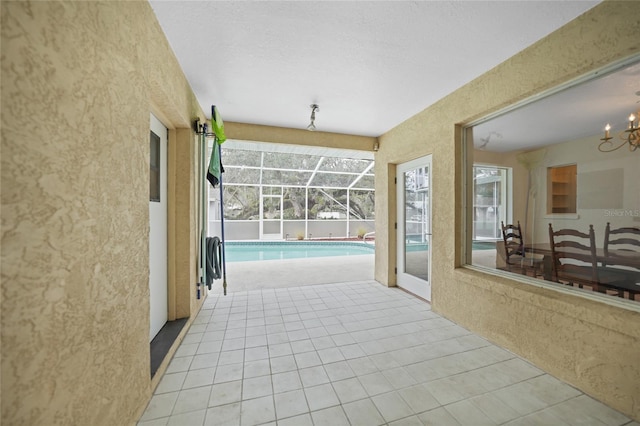 view of patio featuring an outdoor pool and glass enclosure