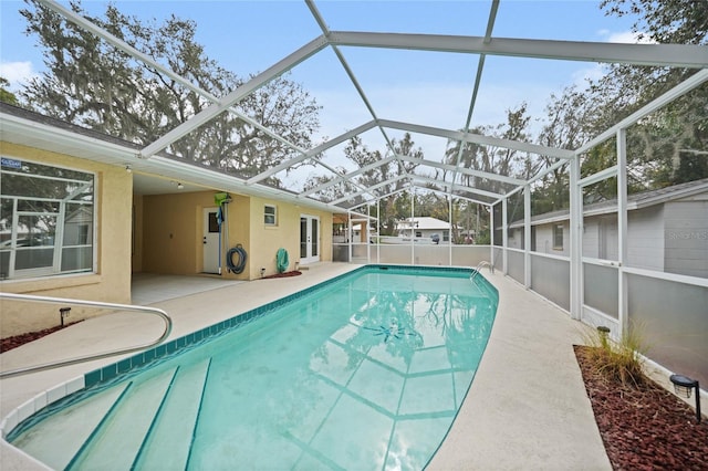 view of swimming pool featuring a lanai, a patio, and a fenced in pool