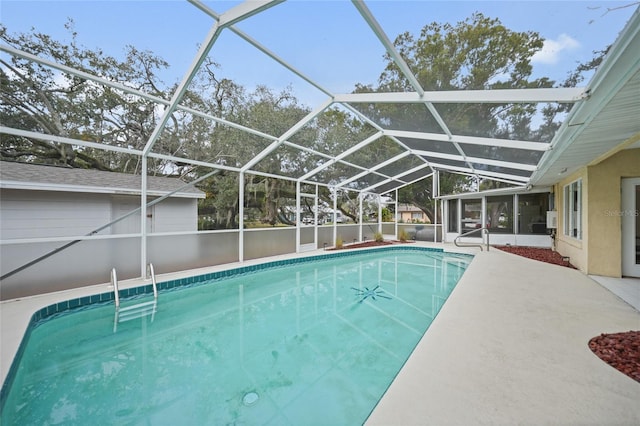 outdoor pool with a patio, glass enclosure, and a sunroom
