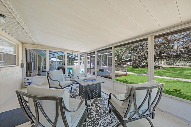 sunroom / solarium featuring an outdoor living space with a fire pit