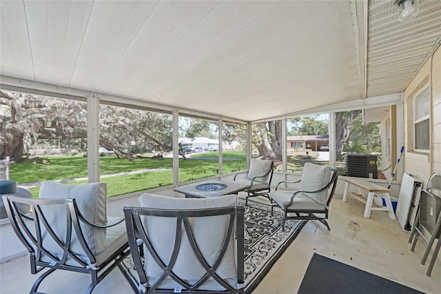 sunroom / solarium with a fire pit and a healthy amount of sunlight