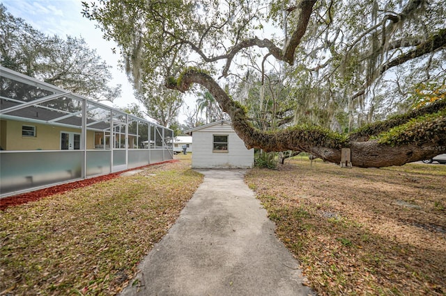 view of property exterior with glass enclosure