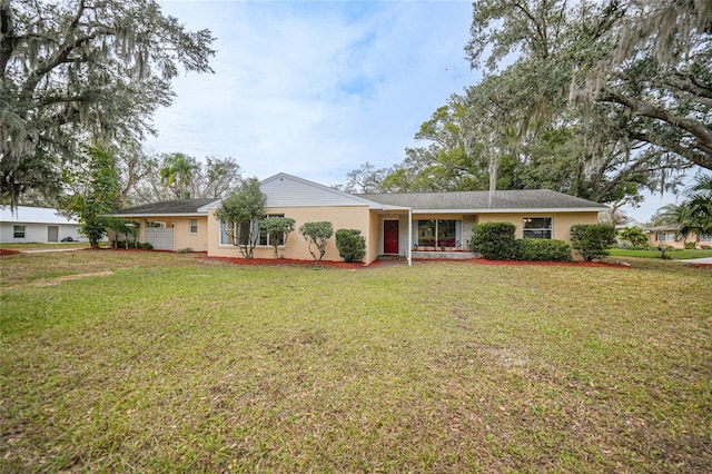 single story home featuring stucco siding and a front yard