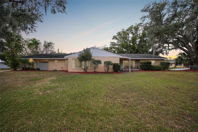 exterior space featuring stucco siding and a front lawn