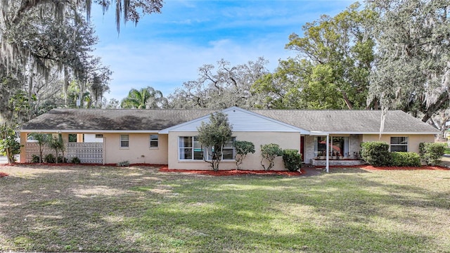 ranch-style house with a front lawn and stucco siding