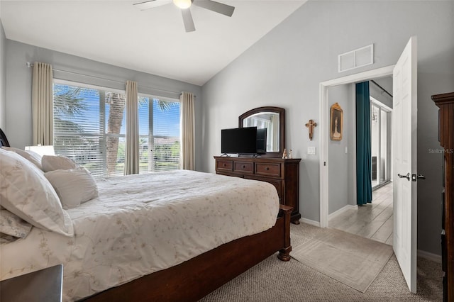 bedroom featuring ceiling fan, visible vents, light carpet, baseboards, and lofted ceiling