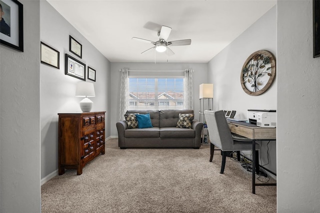 home office with carpet, a ceiling fan, and baseboards