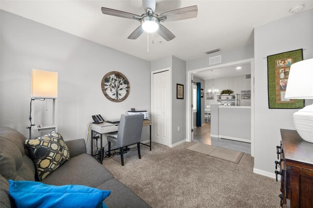 office featuring baseboards, visible vents, a ceiling fan, and carpet flooring