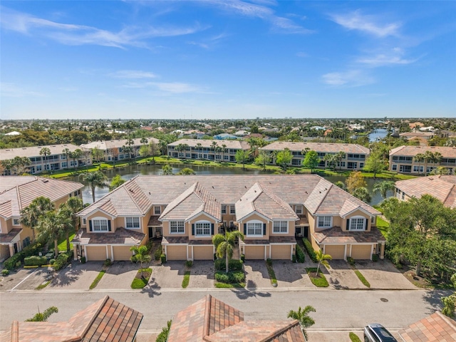 drone / aerial view with a residential view and a water view