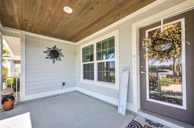 view of exterior entry with covered porch